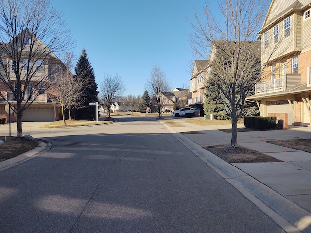 view of street with a residential view and curbs