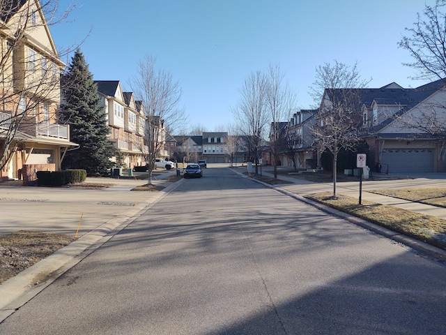 view of street with curbs, a residential view, and sidewalks