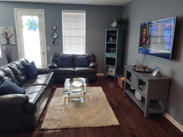 living room with dark wood-style floors and baseboards