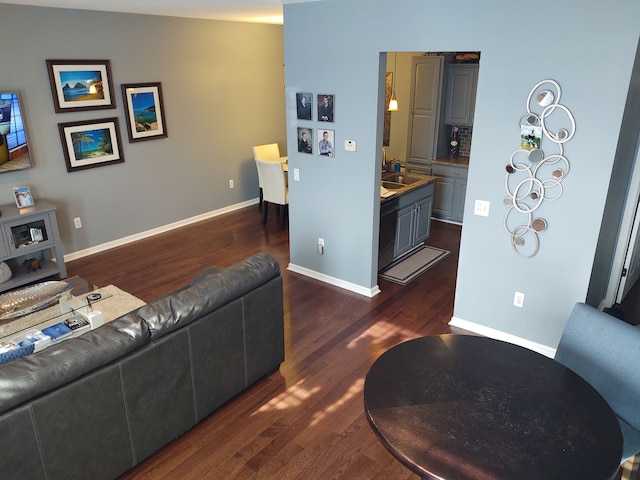 living area featuring dark wood finished floors and baseboards