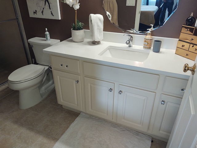 bathroom featuring tile patterned floors, toilet, and vanity