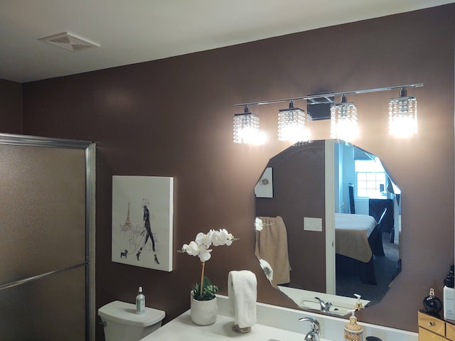 bathroom featuring toilet and visible vents