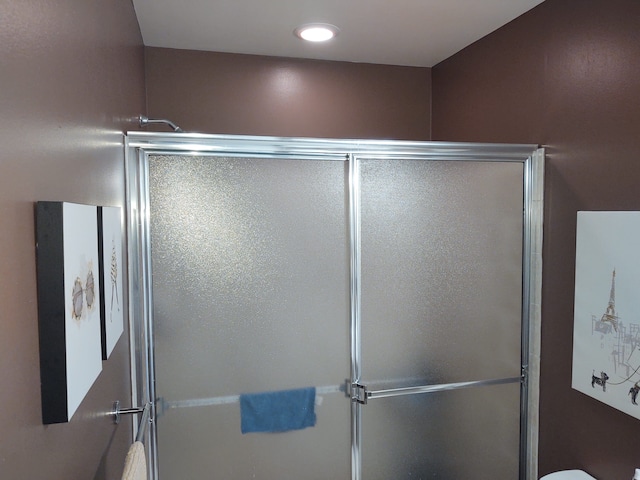 bathroom featuring recessed lighting and a shower stall