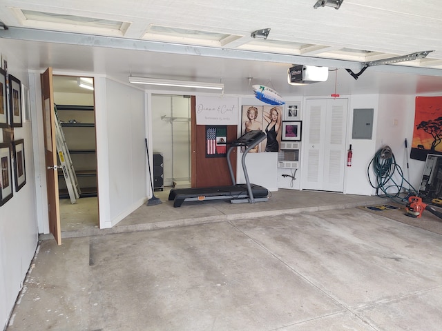 garage with electric panel and a garage door opener