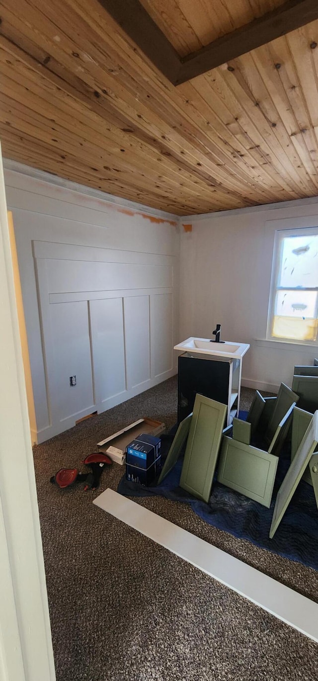 interior space featuring wood ceiling and carpet floors