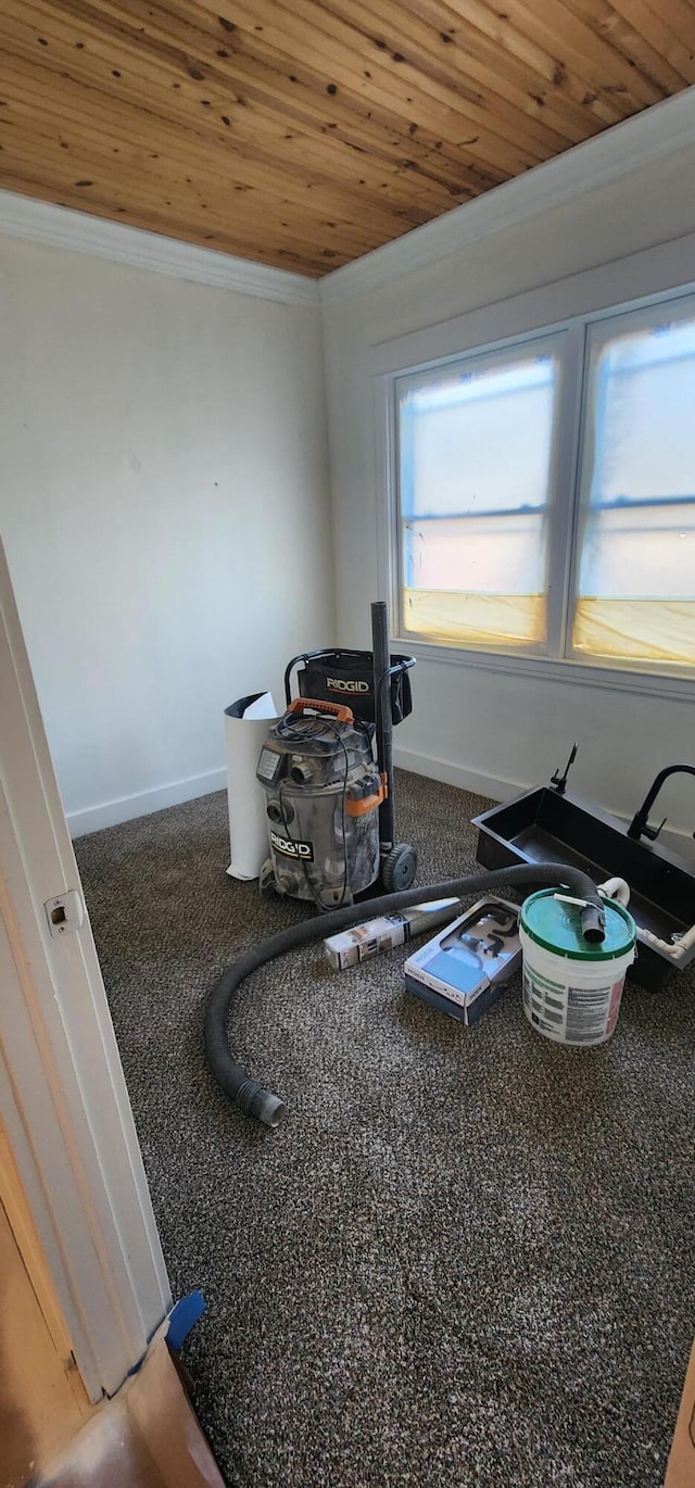 misc room with baseboards, wooden ceiling, and ornamental molding