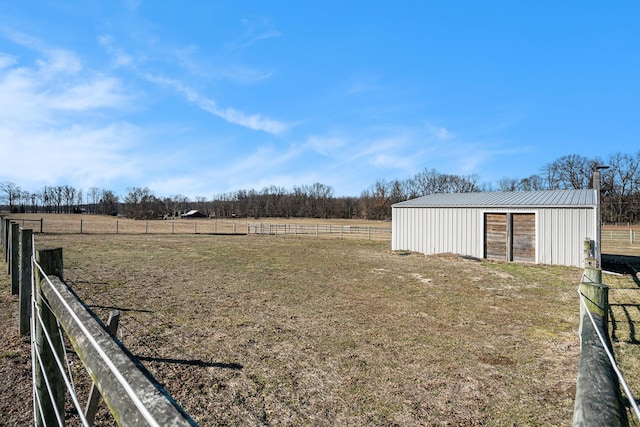 view of yard with an outbuilding, a rural view, fence, and a pole building