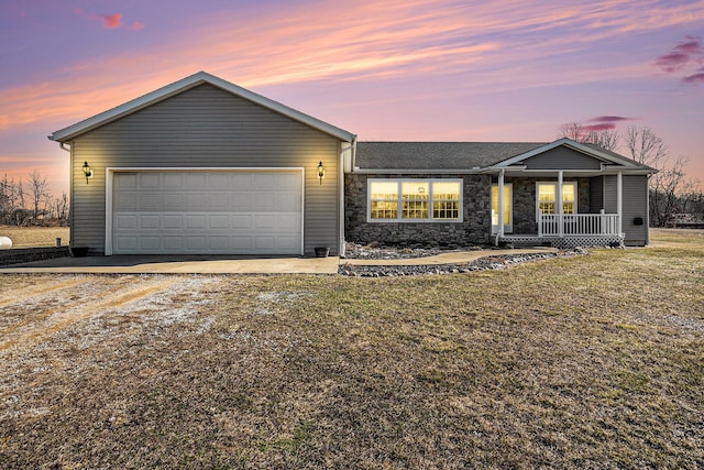 single story home featuring dirt driveway, a front yard, covered porch, stone siding, and an attached garage