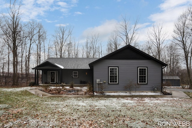 exterior space featuring roof with shingles