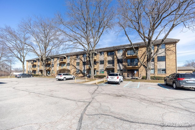 view of building exterior featuring uncovered parking