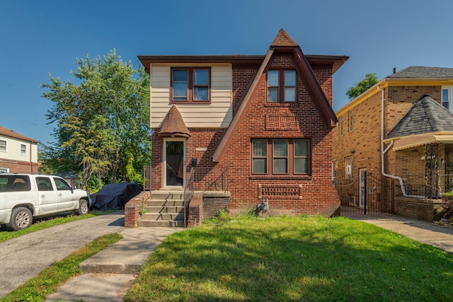 view of front facade with a front lawn and brick siding