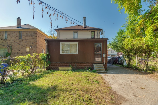 exterior space with entry steps and brick siding