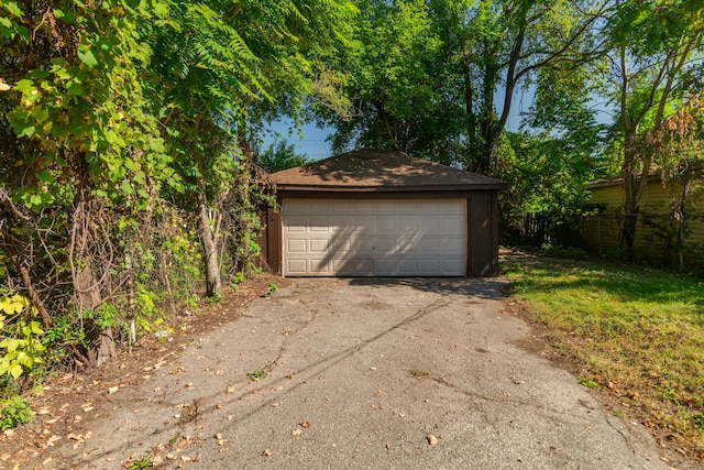 detached garage featuring fence