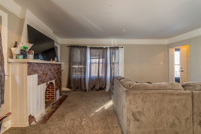 living area featuring a wealth of natural light, carpet, and a fireplace