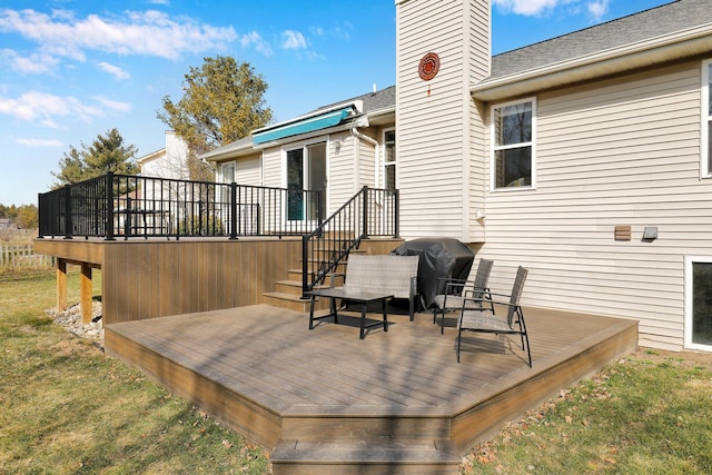 wooden terrace with a grill and a yard