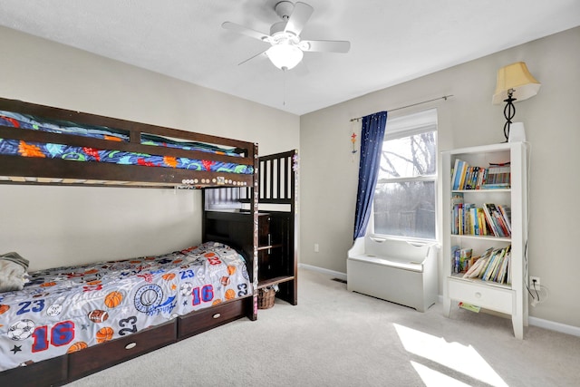 carpeted bedroom featuring baseboards and a ceiling fan