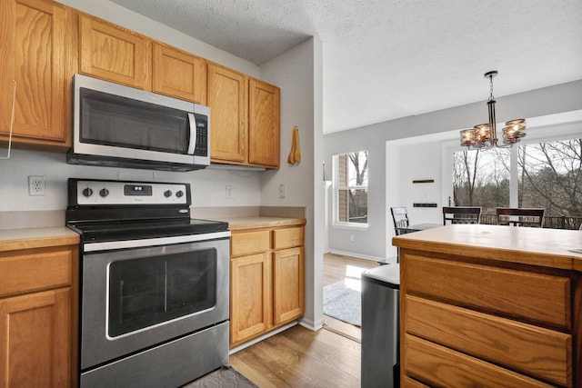 kitchen with light countertops, a healthy amount of sunlight, and appliances with stainless steel finishes