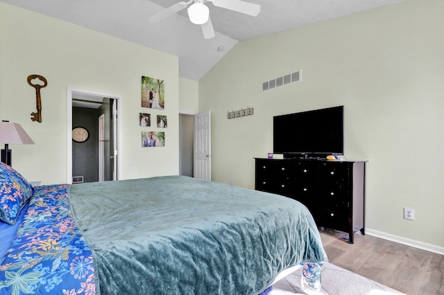 bedroom featuring visible vents, ceiling fan, baseboards, lofted ceiling, and wood finished floors