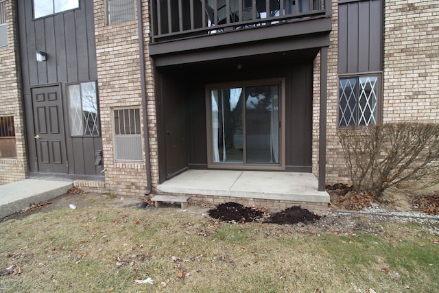 entrance to property featuring brick siding