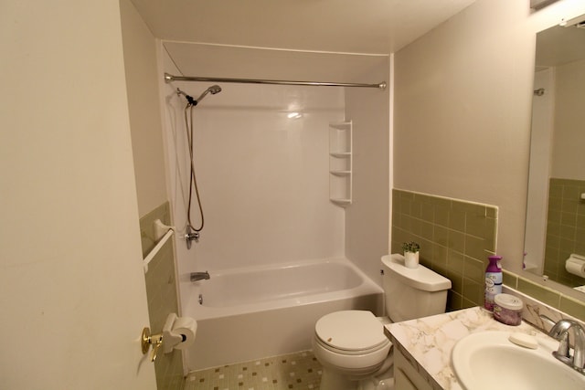 full bath featuring a wainscoted wall, toilet, vanity, tile walls, and  shower combination