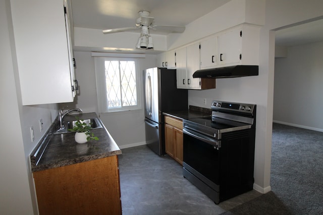 kitchen featuring range with electric cooktop, under cabinet range hood, freestanding refrigerator, white cabinetry, and a sink