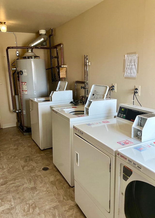 common laundry area featuring independent washer and dryer and water heater