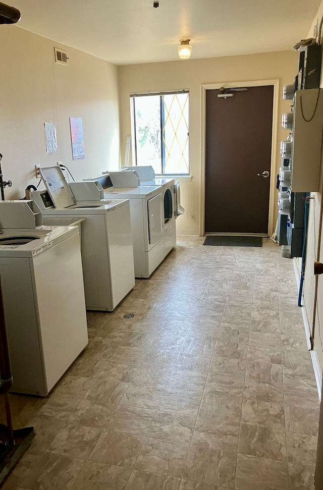 shared laundry area with washer and dryer and visible vents