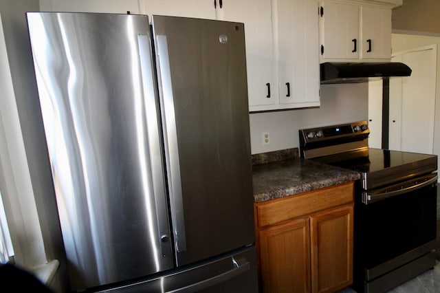 kitchen featuring under cabinet range hood, stainless steel appliances, dark countertops, and brown cabinetry