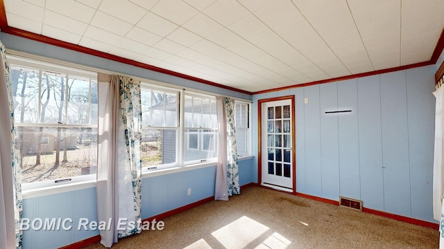 unfurnished sunroom featuring visible vents and plenty of natural light