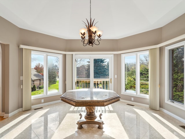 sunroom / solarium with a wealth of natural light, visible vents, and a notable chandelier