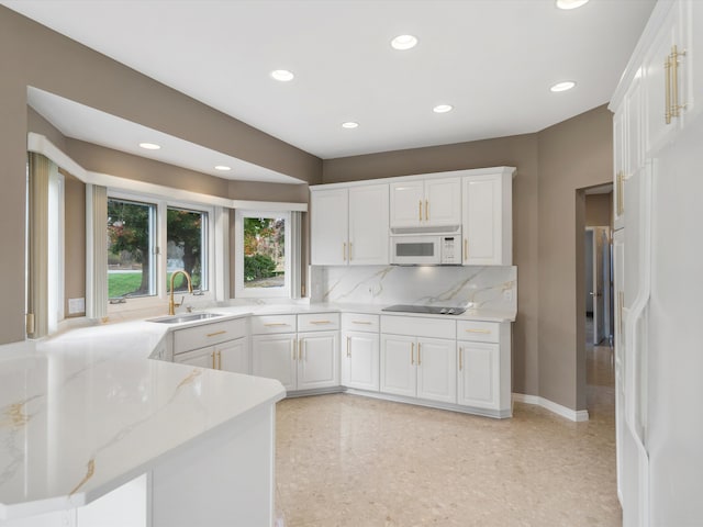 kitchen with a sink, white cabinetry, recessed lighting, white appliances, and decorative backsplash