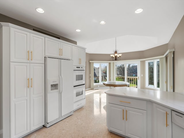 kitchen featuring recessed lighting, white appliances, white cabinets, and light countertops