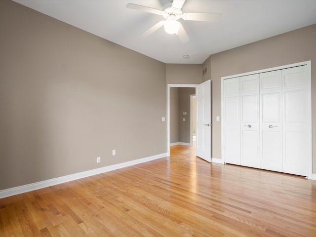 unfurnished bedroom with a ceiling fan, visible vents, baseboards, a closet, and light wood-type flooring