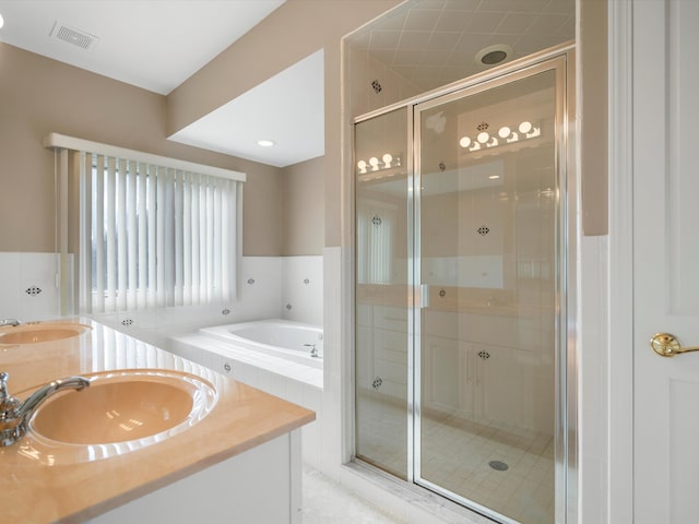 bathroom with a sink, visible vents, a stall shower, and a bath