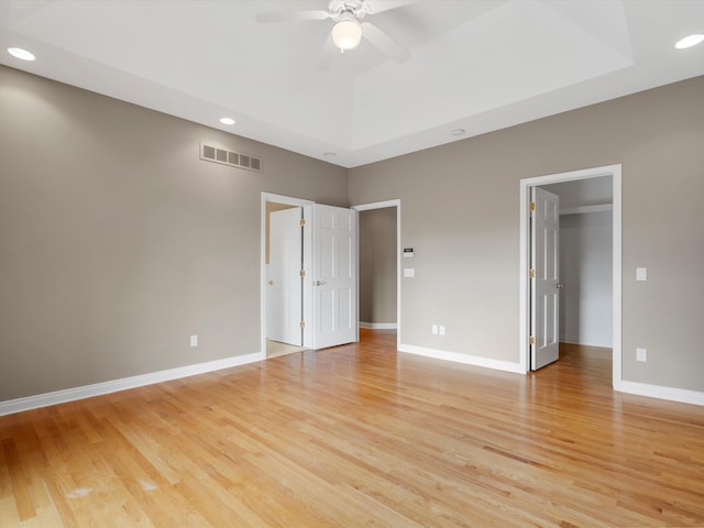 unfurnished bedroom with baseboards, visible vents, light wood-style flooring, recessed lighting, and a spacious closet