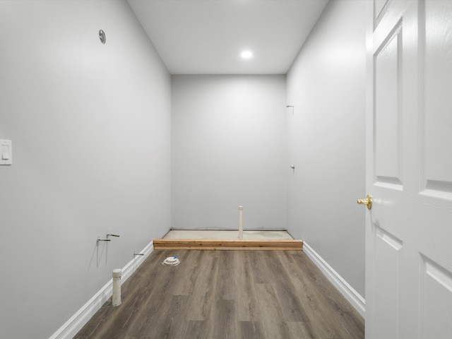 laundry room with baseboards and wood finished floors