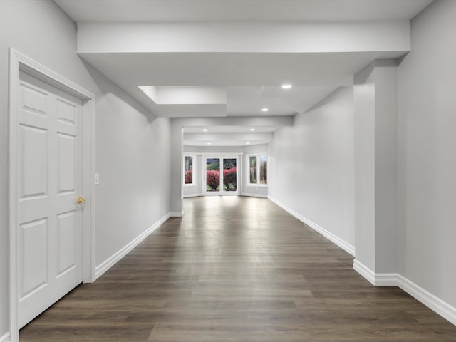 unfurnished living room featuring recessed lighting, baseboards, and dark wood-type flooring