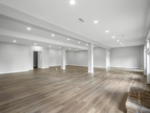 basement featuring recessed lighting, wood finished floors, and baseboards