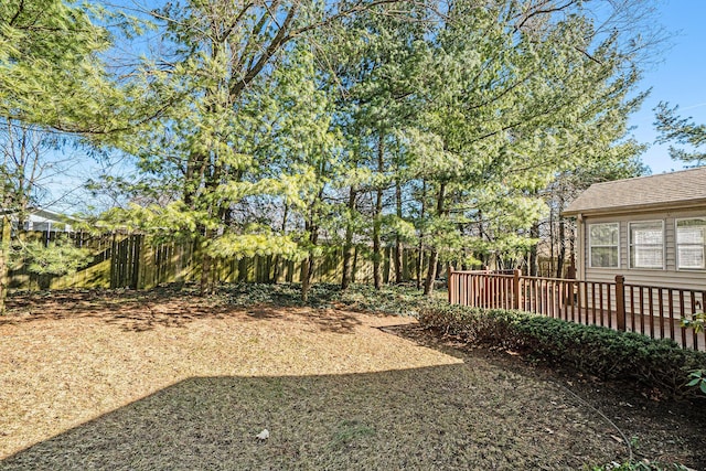 view of yard with a deck and fence