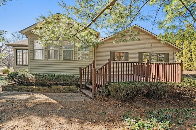 back of house featuring a wooden deck