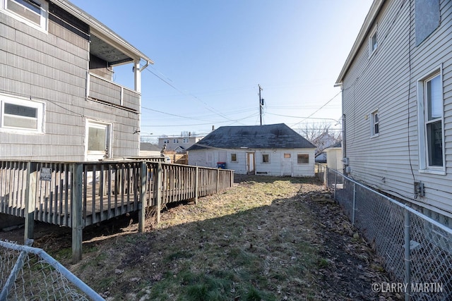 view of yard with a wooden deck and fence