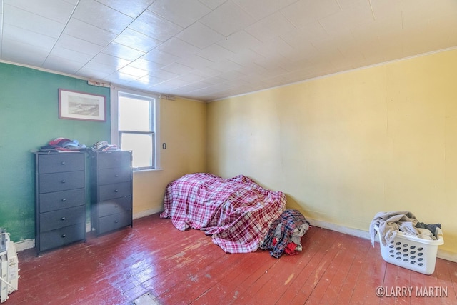 bedroom with baseboards, hardwood / wood-style floors, and crown molding