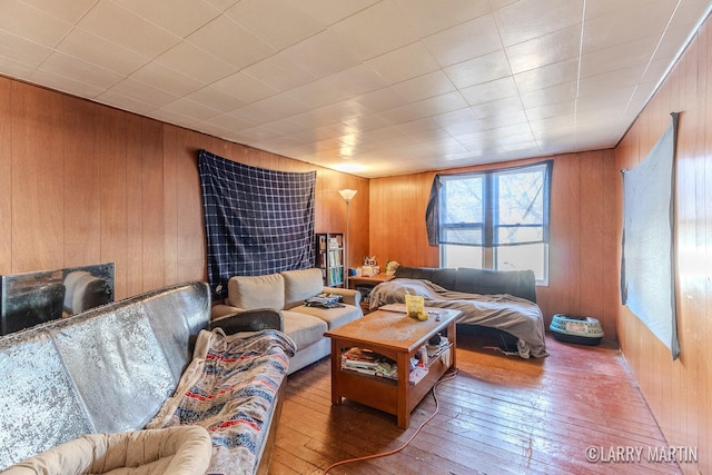 living area with wood walls and wood-type flooring