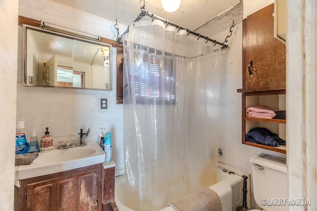 full bathroom featuring toilet, vanity, and shower / tub combo with curtain