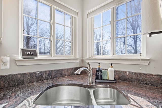 details with dark stone counters and a sink