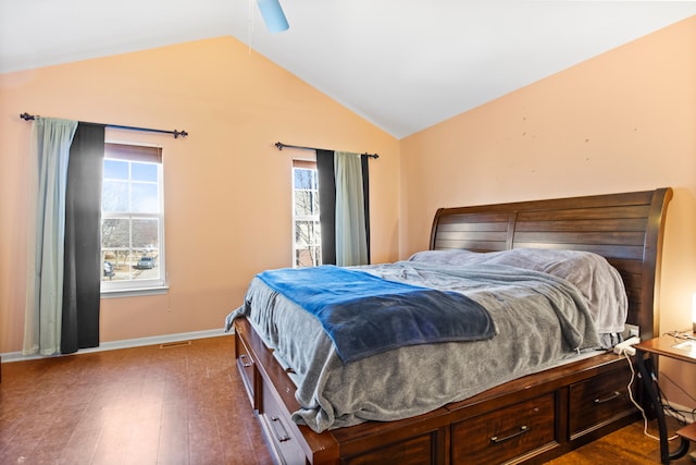 bedroom featuring dark wood finished floors, multiple windows, a ceiling fan, and lofted ceiling