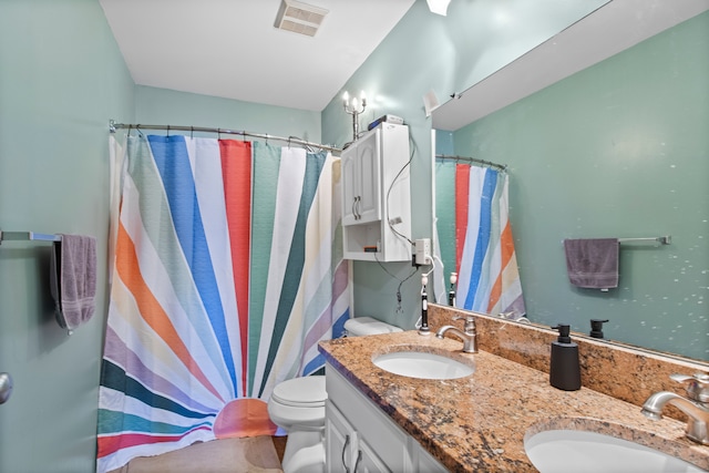 bathroom with double vanity, visible vents, toilet, and a sink