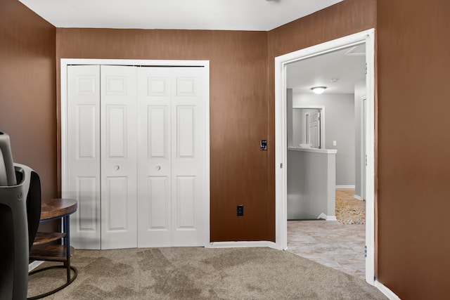 bedroom featuring a closet, baseboards, and carpet