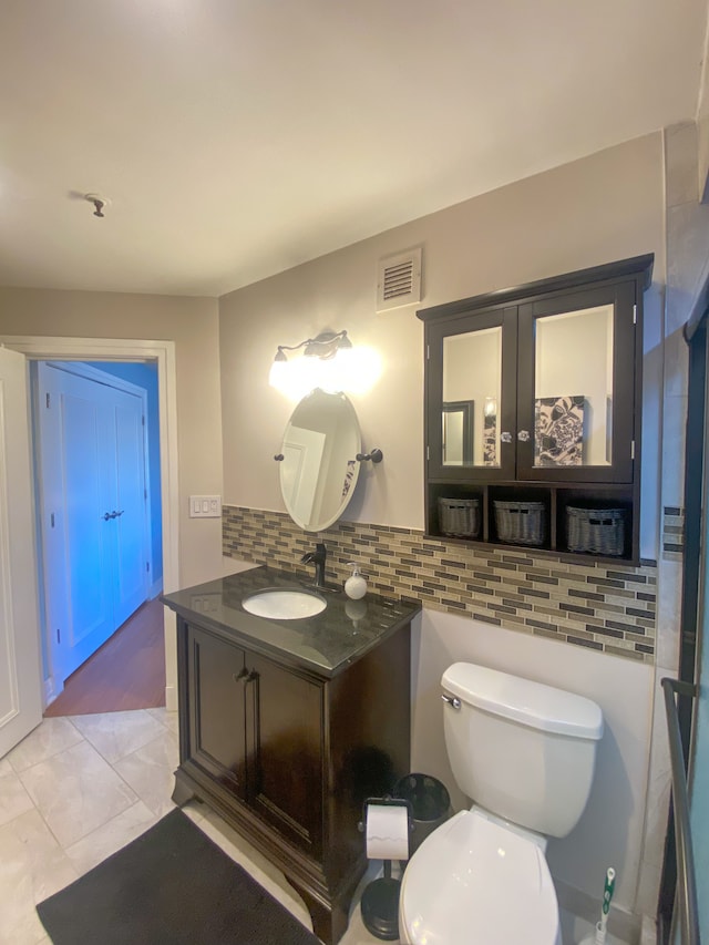 bathroom featuring visible vents, toilet, decorative backsplash, tile patterned floors, and vanity