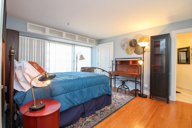 bedroom with baseboards and wood finished floors